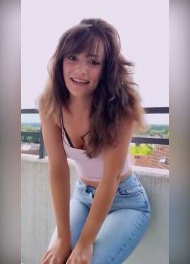 german girl in tight jeans flashing her tits on the balcony